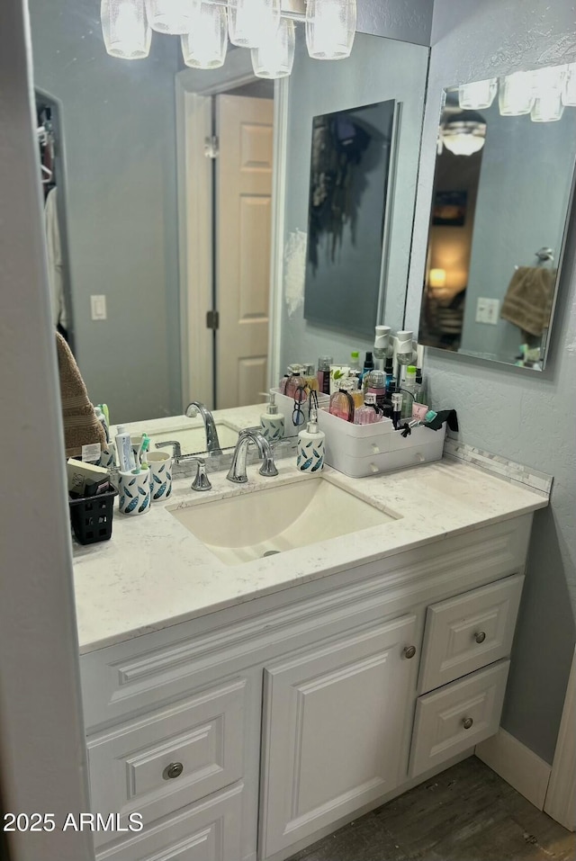 bathroom with baseboards and vanity