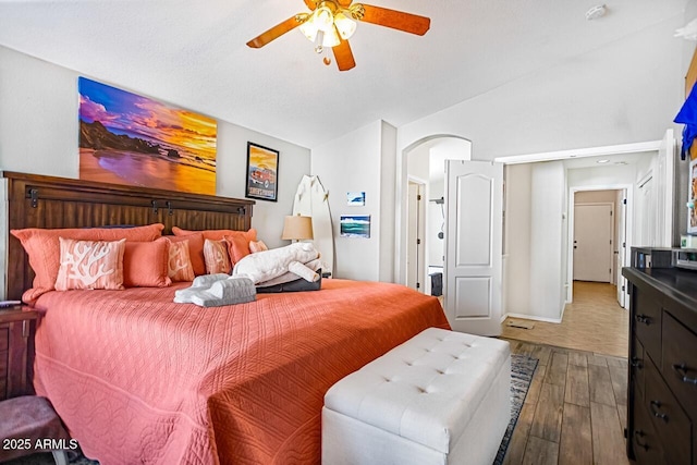 bedroom featuring lofted ceiling, hardwood / wood-style flooring, and ceiling fan