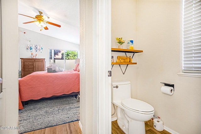 bathroom with ceiling fan, lofted ceiling, toilet, and hardwood / wood-style floors