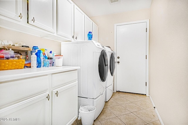 washroom with cabinets, light tile patterned flooring, and separate washer and dryer