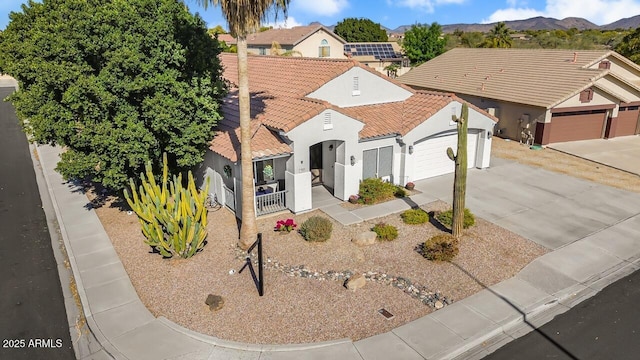 view of front of property featuring a garage and a mountain view