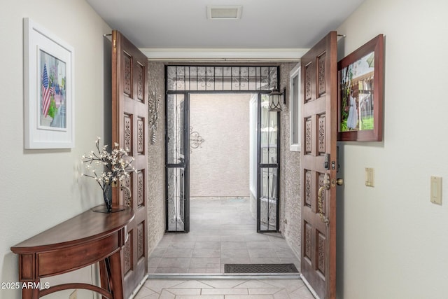 hall featuring light tile patterned floors