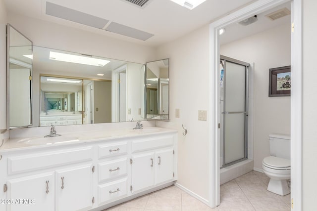 bathroom featuring toilet, an enclosed shower, tile patterned flooring, and vanity