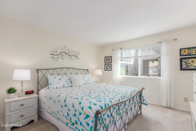 bedroom featuring light carpet