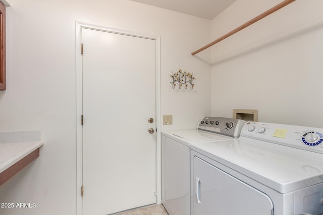 clothes washing area featuring separate washer and dryer