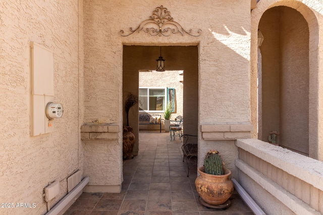 view of exterior entry featuring a patio area