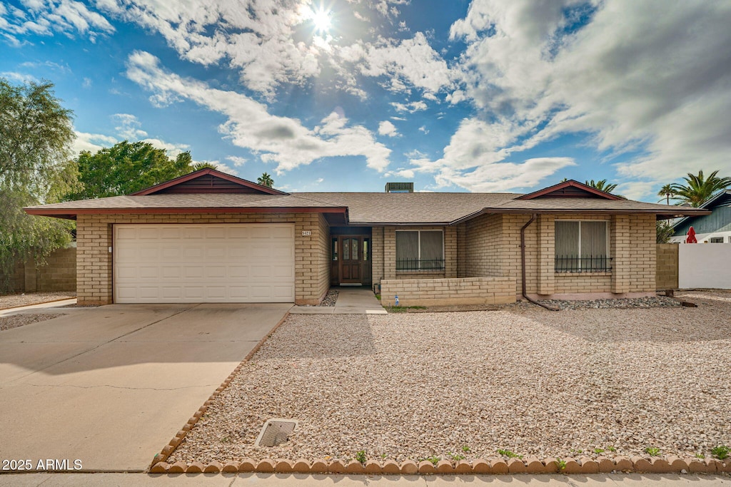 ranch-style home featuring a garage