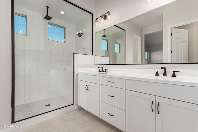 bathroom with vanity and tiled shower