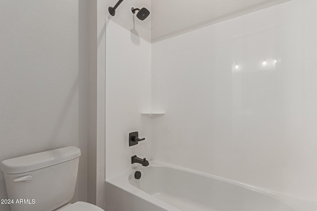 bathroom featuring toilet and bathing tub / shower combination