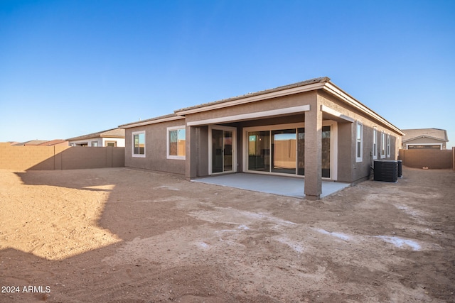 rear view of property with a patio and cooling unit