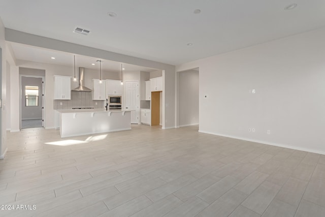 unfurnished living room featuring light hardwood / wood-style floors