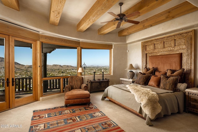 bedroom featuring light colored carpet, beam ceiling, a mountain view, and access to outside