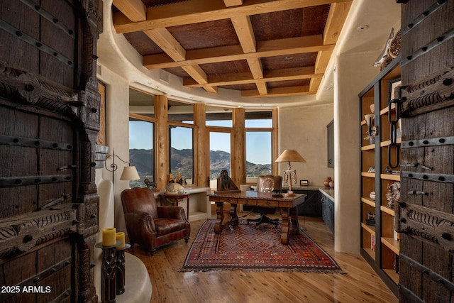 office featuring coffered ceiling, a mountain view, wood-type flooring, and beamed ceiling