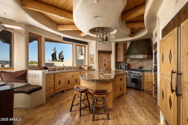 kitchen with a kitchen island with sink, stainless steel appliances, custom range hood, and wooden ceiling