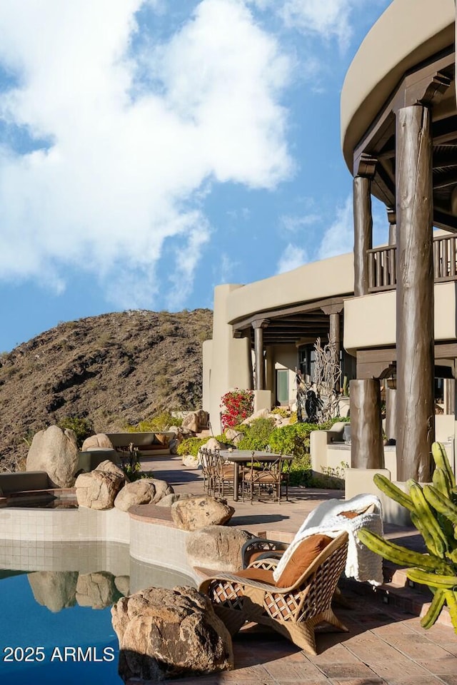 view of patio / terrace featuring a mountain view