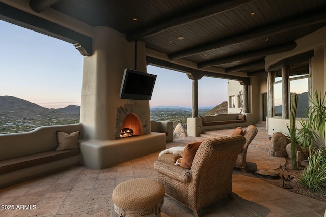 view of patio with an outdoor living space with a fireplace