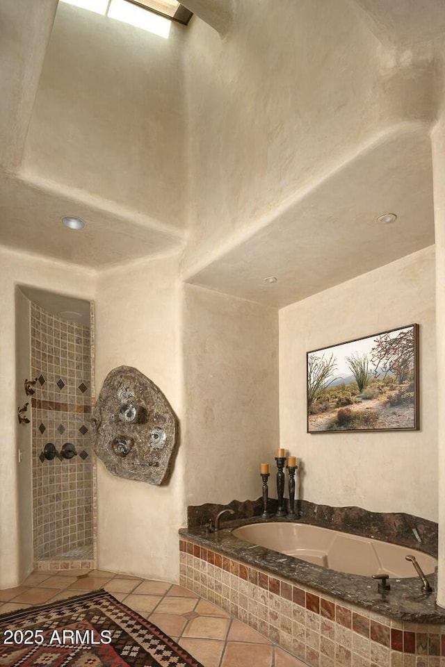 bathroom featuring tile patterned flooring and plus walk in shower