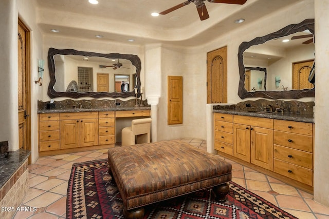 bathroom featuring tile patterned flooring, vanity, and ceiling fan