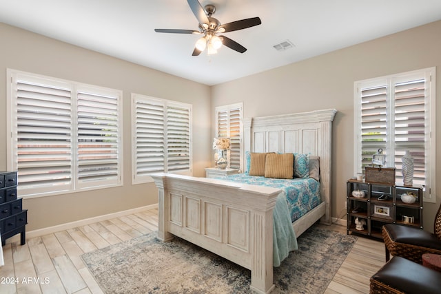 bedroom with light hardwood / wood-style flooring and ceiling fan