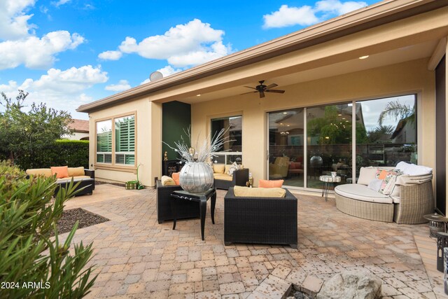 view of patio with outdoor lounge area and ceiling fan