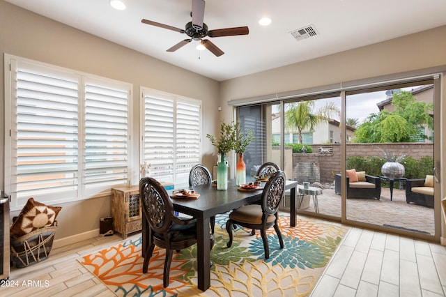 dining room with plenty of natural light, ceiling fan, and light hardwood / wood-style flooring