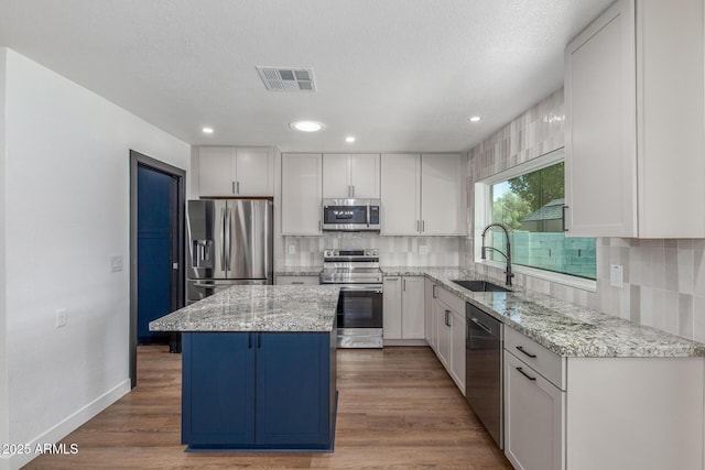 8602 N 42nd Dr, Phoenix, AZ 85051 - kitchen with appliances with stainless steel finishes, white cabinets, tasteful backsplash, light stone countertops, and recessed lighting
