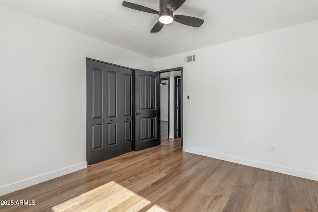 8602 N 42nd Dr, Phoenix, AZ 85051 - unfurnished bedroom with wood finished floors, a closet, and ceiling fan