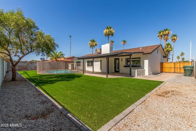 8602 N 42nd Dr, Phoenix, AZ 85051 - back of house featuring a patio, a fenced backyard, stucco siding, and a chimney