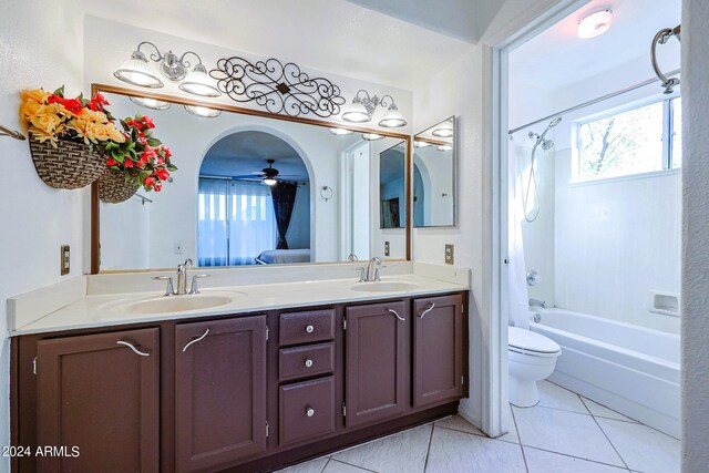 full bathroom with tile patterned floors, shower / tub combo, ceiling fan, vanity, and toilet