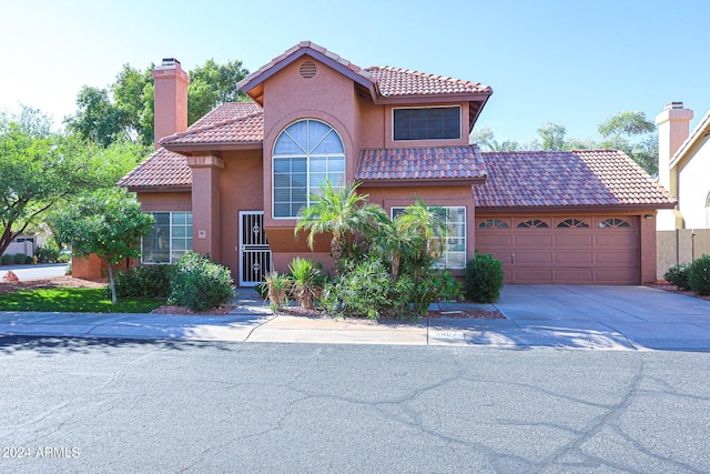 mediterranean / spanish-style house with a garage