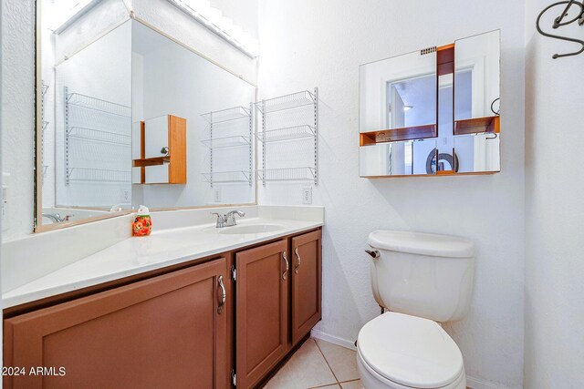 bathroom with tile patterned floors, vanity, and toilet