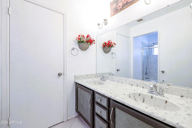 bathroom with vanity, a shower, and tile patterned flooring