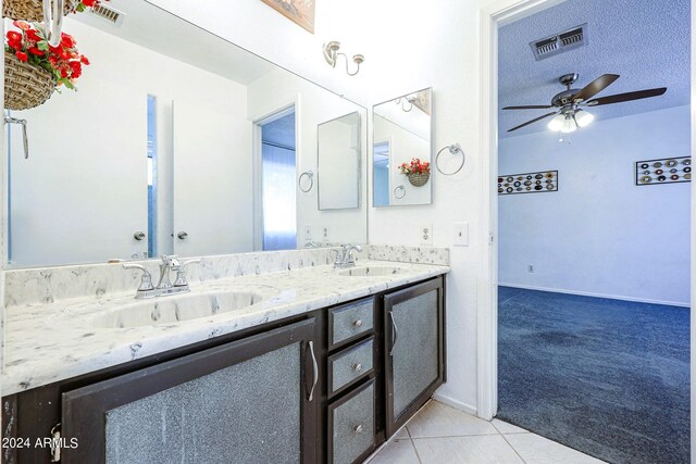 bathroom featuring a textured ceiling, vanity, ceiling fan, and tile patterned floors