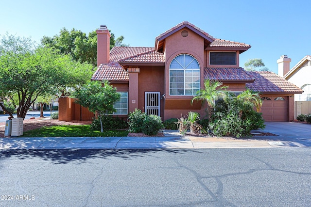 mediterranean / spanish-style house featuring a garage