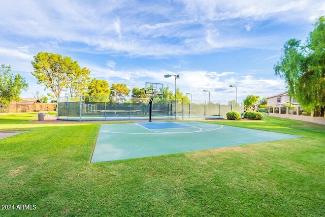 view of sport court with a yard