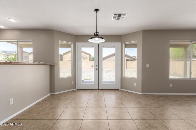 906 S 242nd Dr, Buckeye, AZ 85326 - unfurnished dining area featuring baseboards, tile patterned floors, and french doors