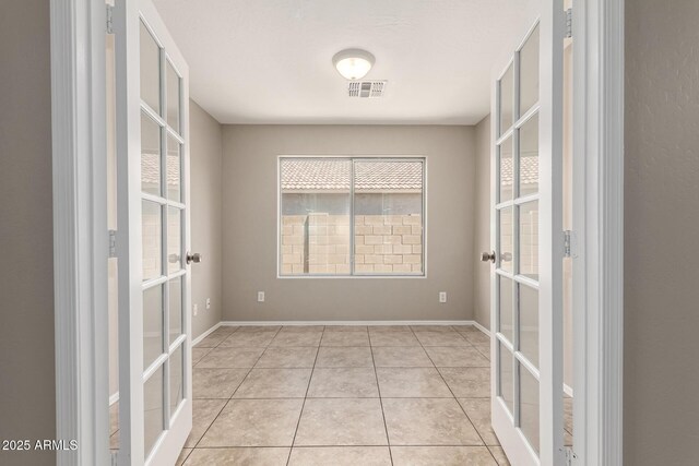 906 S 242nd Dr, Buckeye, AZ 85326 - spare room featuring french doors and light tile patterned flooring