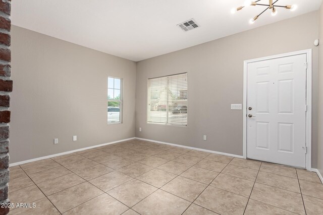 906 S 242nd Dr, Buckeye, AZ 85326 - spare room featuring a chandelier, light tile patterned floors, and baseboards