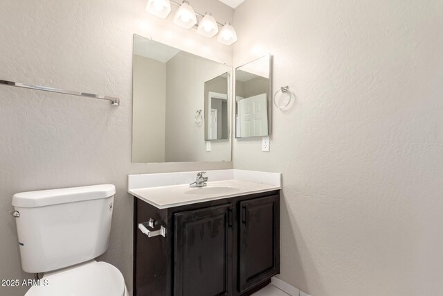 906 S 242nd Dr, Buckeye, AZ 85326 - bathroom featuring toilet, vanity, and a textured wall