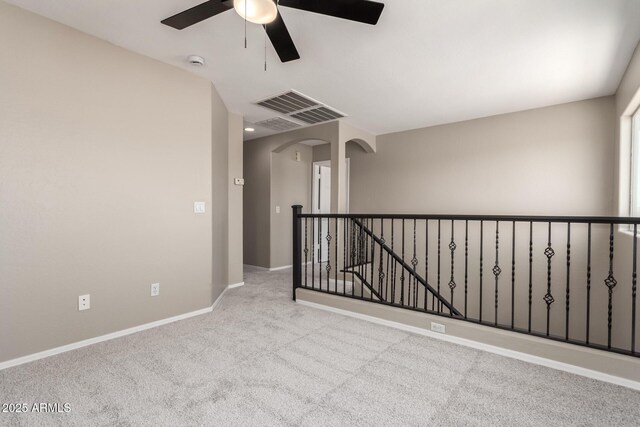 906 S 242nd Dr, Buckeye, AZ 85326 - spare room featuring carpet flooring, ceiling fan, arched walkways, a smoke detector, and baseboards