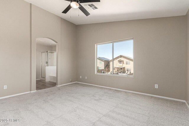 906 S 242nd Dr, Buckeye, AZ 85326 - unfurnished bedroom featuring arched walkways, carpet floors, connected bathroom, and baseboards