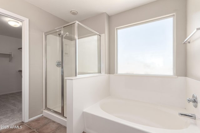 906 S 242nd Dr, Buckeye, AZ 85326 - bathroom featuring a shower stall, a bath, and a walk in closet