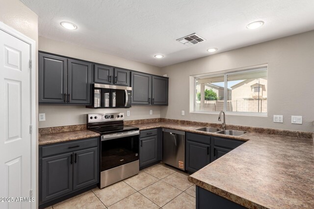 906 S 242nd Dr, Buckeye, AZ 85326 - kitchen with appliances with stainless steel finishes, a sink, light tile patterned floors, and recessed lighting
