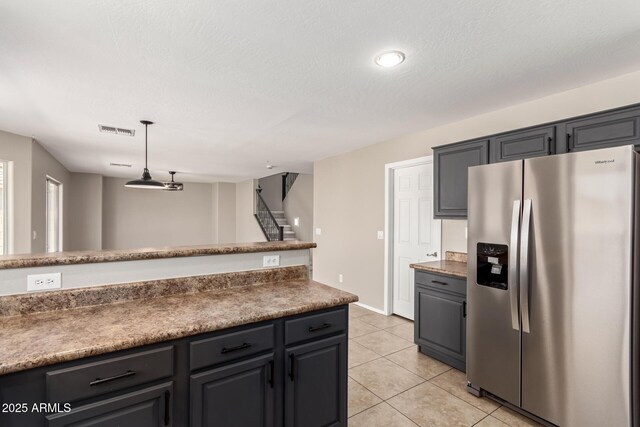 906 S 242nd Dr, Buckeye, AZ 85326 - kitchen with stainless steel fridge with ice dispenser, light tile patterned floors, pendant lighting, and baseboards