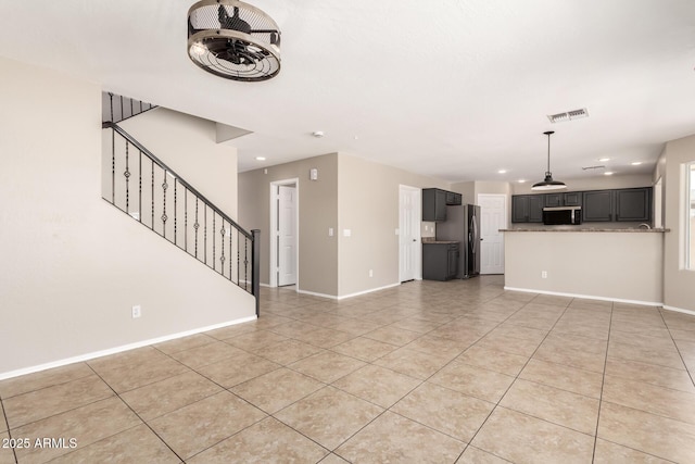 906 S 242nd Dr, Buckeye, AZ 85326 - unfurnished living room with light tile patterned floors, stairs, baseboards, and recessed lighting