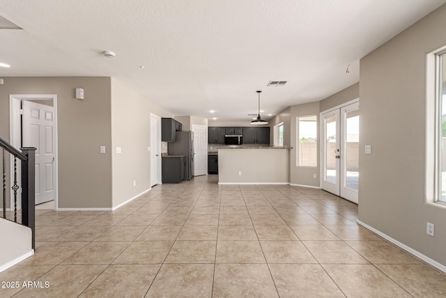 906 S 242nd Dr, Buckeye, AZ 85326 - unfurnished living room featuring french doors, light tile patterned floors, stairway, baseboards, and recessed lighting
