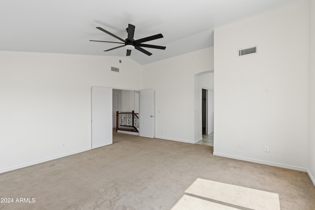 carpeted empty room featuring vaulted ceiling and ceiling fan