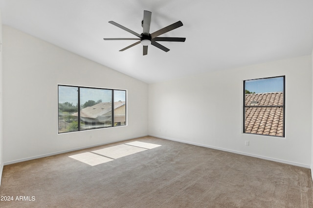 carpeted empty room featuring ceiling fan and lofted ceiling