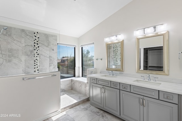 bathroom with vanity, walk in shower, and lofted ceiling