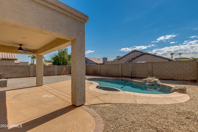 view of swimming pool featuring ceiling fan and a patio